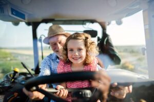 Girl With Grandpa Driving Tractor | SPV Soils